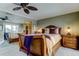 This main bedroom features an ornate bed, mirrored wall, ceiling fan, and balcony access at 936 Pinellas Bayway S # T-7, Tierra Verde, FL 33715
