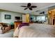 Spacious main bedroom boasts a ceiling fan, mirrored wall, adjacent sitting area, and ensuite bath at 936 Pinellas Bayway S # T-7, Tierra Verde, FL 33715