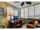 Cozy office area features a desk, comfortable chair, ceiling fan, and lovely natural light at 936 Pinellas Bayway S # T-7, Tierra Verde, FL 33715