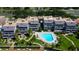 Overhead shot of condos with a community pool, complemented by lush greenery, and a waterfront dock at 936 Pinellas Bayway S # T-7, Tierra Verde, FL 33715
