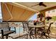 Outdoor balcony with shade awning with seating offers a serene view of the pool and surrounding scenery at 936 Pinellas Bayway S # T-7, Tierra Verde, FL 33715