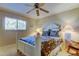 Cozy bedroom featuring a ceiling fan, window letting in natural light, and a comfortable-looking bed at 936 Pinellas Bayway S # T-7, Tierra Verde, FL 33715