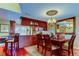 Elegant dining room with cherry wood floors, cabinets, and chandelier at 936 Pinellas Bayway S # T-7, Tierra Verde, FL 33715