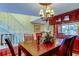 Dining room features cherry wood table, matching cabinet, and chandelier at 936 Pinellas Bayway S # T-7, Tierra Verde, FL 33715