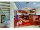 View of the dining area with hardwood floors, a chandelier, and a staircase to the upper level at 936 Pinellas Bayway S # T-7, Tierra Verde, FL 33715
