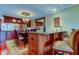 Stylish dining room with hardwood floors, decorative lighting, and bar seating at 936 Pinellas Bayway S # T-7, Tierra Verde, FL 33715