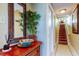 Inviting entryway with wooden furniture, stylish mirror and staircase with carpet runner at 936 Pinellas Bayway S # T-7, Tierra Verde, FL 33715