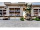 Beautiful three-story condo building featuring private balconies, garages, and tropical landscaping at 936 Pinellas Bayway S # T-7, Tierra Verde, FL 33715