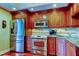 Cherry wood kitchen features stainless steel appliances and elegant granite countertops at 936 Pinellas Bayway S # T-7, Tierra Verde, FL 33715