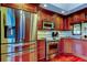 Kitchen featuring stainless steel appliances, granite countertops, and cherry wood cabinets at 936 Pinellas Bayway S # T-7, Tierra Verde, FL 33715