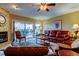 Comfortable living room with fireplace, leather seating, and sliding glass doors to the balcony at 936 Pinellas Bayway S # T-7, Tierra Verde, FL 33715