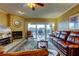 Comfortable living room with fireplace, leather seating, and sliding glass doors to the balcony at 936 Pinellas Bayway S # T-7, Tierra Verde, FL 33715