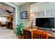 Home office featuring a large desk, blinds on the window, and a view into the bedroom at 936 Pinellas Bayway S # T-7, Tierra Verde, FL 33715