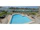 Beautiful waterfront pool with lounge chairs and tables and a marina view at 936 Pinellas Bayway S # T-7, Tierra Verde, FL 33715