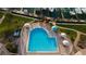 Aerial view of the community pool area, surrounded by umbrellas and chairs, next to the marina at 936 Pinellas Bayway S # T-7, Tierra Verde, FL 33715