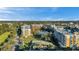 This aerial perspective showcases the condo community, highlighting the buildings, pool area, and picturesque pond setting at 960 Starkey Rd # 3406, Largo, FL 33771
