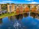 Stunning aerial view of condo buildings with a beautiful lake and fountain at 960 Starkey Rd # 3406, Largo, FL 33771
