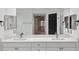 Bathroom featuring dual sinks with quartz countertops and white cabinets, and a large mirror at 960 Starkey Rd # 3406, Largo, FL 33771