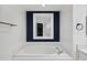 Modern bathroom features a soaking tub with stylish fixtures and a mirror at 960 Starkey Rd # 3406, Largo, FL 33771