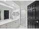 Bathroom showcasing a vanity with white cabinets, quartz countertop and a glass enclosed walk-in shower at 960 Starkey Rd # 3406, Largo, FL 33771
