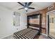 This bedroom features modern wood-look accent wall with a murphy bed with doors to the balcony at 960 Starkey Rd # 3406, Largo, FL 33771