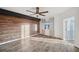 Modern bedroom featuring a wood accent wall, wood-look flooring, ceiling fan, and natural light at 960 Starkey Rd # 3406, Largo, FL 33771
