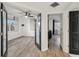 Bright bedroom featuring wood-look flooring, white walls, black french doors and a ceiling fan at 960 Starkey Rd # 3406, Largo, FL 33771