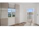 Bedroom with window, hardwood floors, and balcony access showcasing natural light and views at 960 Starkey Rd # 3406, Largo, FL 33771