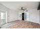 Bedroom featuring wood floors, neutral walls, ceiling fan, and access to the ensuite bathroom at 960 Starkey Rd # 3406, Largo, FL 33771
