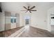 Bright bedroom features hardwood floors, balcony access, and a ceiling fan adding to its charm at 960 Starkey Rd # 3406, Largo, FL 33771