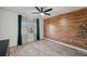 This spacious bedroom features a wood-look accent wall and modern ceiling fan at 960 Starkey Rd # 3406, Largo, FL 33771