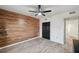 This spacious bedroom features a wood-look accent wall and modern ceiling fan at 960 Starkey Rd # 3406, Largo, FL 33771