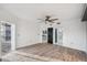 Bedroom featuring wood floors, neutral walls, ceiling fan, and access to the ensuite bathroom at 960 Starkey Rd # 3406, Largo, FL 33771