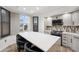 Modern kitchen featuring stainless steel appliances, gray cabinets, tile backsplash, and a large island with seating at 960 Starkey Rd # 3406, Largo, FL 33771