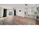 Bright, open floorplan with hardwood floors, ceiling fan, and sliding glass doors to the balcony, perfect for entertaining at 960 Starkey Rd # 3406, Largo, FL 33771