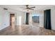 Open living area with beautiful wood floors, ceiling fan, balcony access, and bright natural light at 960 Starkey Rd # 3406, Largo, FL 33771