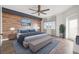 Modern bedroom with wood accent wall, bench, and neutral tones creating a serene atmosphere at 960 Starkey Rd # 3406, Largo, FL 33771