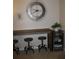 Stylish bar area with counter seating, a modern clock, and a beverage cooler at 9911 Dahlia N St # 38, Pinellas Park, FL 33782