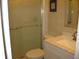Bathroom featuring sliding glass shower door with white vanity and sink at 9911 Dahlia N St # 38, Pinellas Park, FL 33782