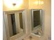 Bright bathroom featuring chrome fixtures, a mirrored medicine cabinet, and white tile at 9911 Dahlia N St # 38, Pinellas Park, FL 33782