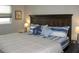 Inviting bedroom features a beautiful wood headboard, soft lighting, and plush bedding at 9911 Dahlia N St # 38, Pinellas Park, FL 33782