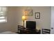 Neutral bedroom featuring dresser with TV, turtle decor, and a bright window at 9911 Dahlia N St # 38, Pinellas Park, FL 33782