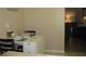 Cozy dining area set for a meal, adjacent to the living area with neutral tones at 9911 Dahlia N St # 38, Pinellas Park, FL 33782