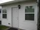 Exterior shot of home featuring a bright white exterior, a white door and two windows at 9911 Dahlia N St # 38, Pinellas Park, FL 33782