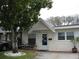 Charming home featuring a decorative tree, brick walkway, and covered front porch at 9911 Dahlia N St # 38, Pinellas Park, FL 33782