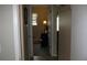 Hallway view leading to a bedroom with a small table and window at 9911 Dahlia N St # 38, Pinellas Park, FL 33782