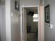 Neutral hallway leading to a bedroom with mounted tv and open door at 9911 Dahlia N St # 38, Pinellas Park, FL 33782