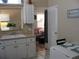 Charming kitchen featuring a window over the sink, with a view into the adjacent room, and a dining table at 9911 Dahlia N St # 38, Pinellas Park, FL 33782