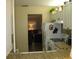 Cozy kitchen with white cabinets and appliances, plus an open view into the living room, offers seamless living at 9911 Dahlia N St # 38, Pinellas Park, FL 33782
