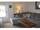 Comfortable living room featuring a large sectional sofa and decorative elements at 9911 Dahlia N St # 38, Pinellas Park, FL 33782